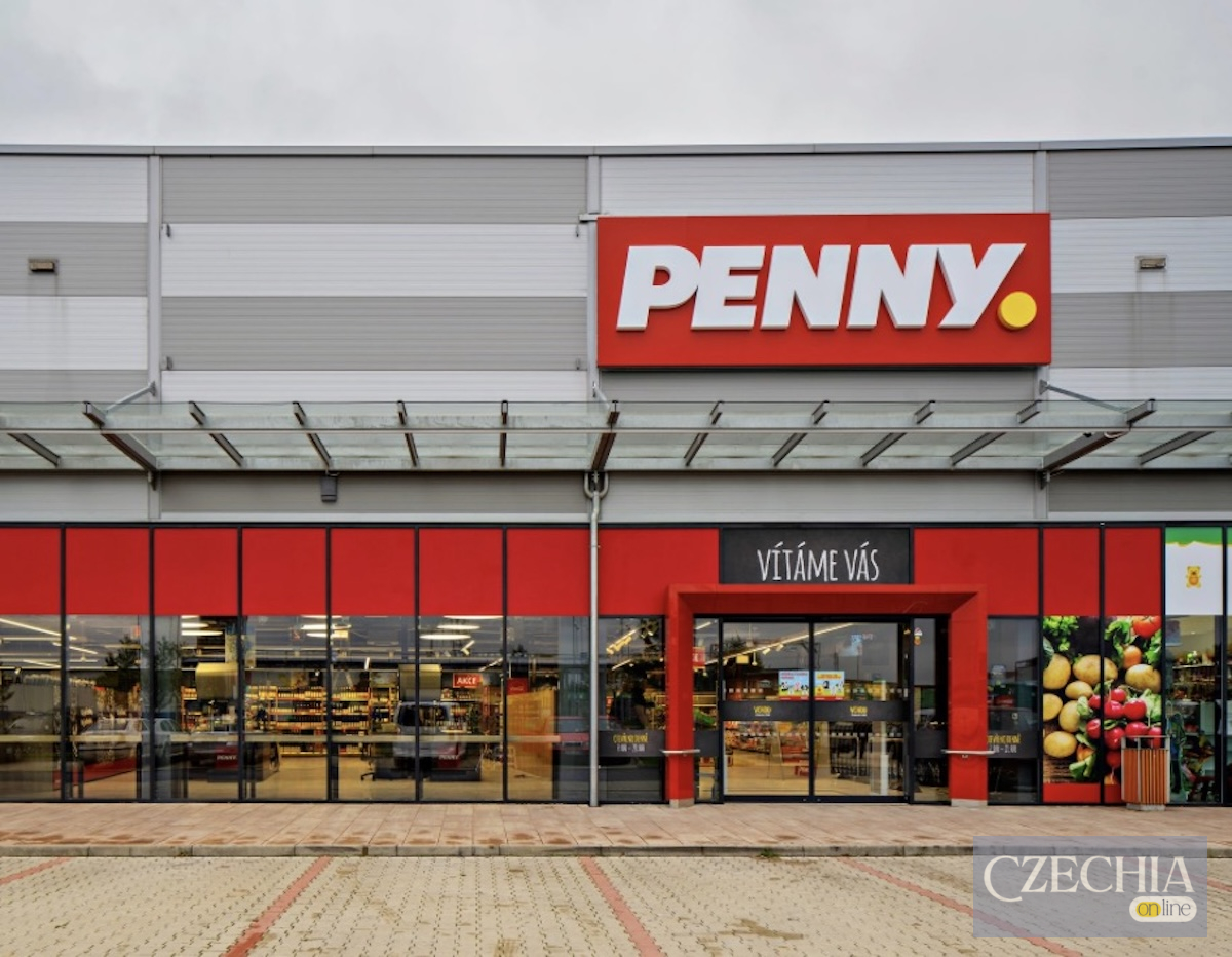 Фасад сучасного супермаркету Penny з червоним логотипом та скляними вітринами. Матеріал про штрафи для чеських торгових мереж.